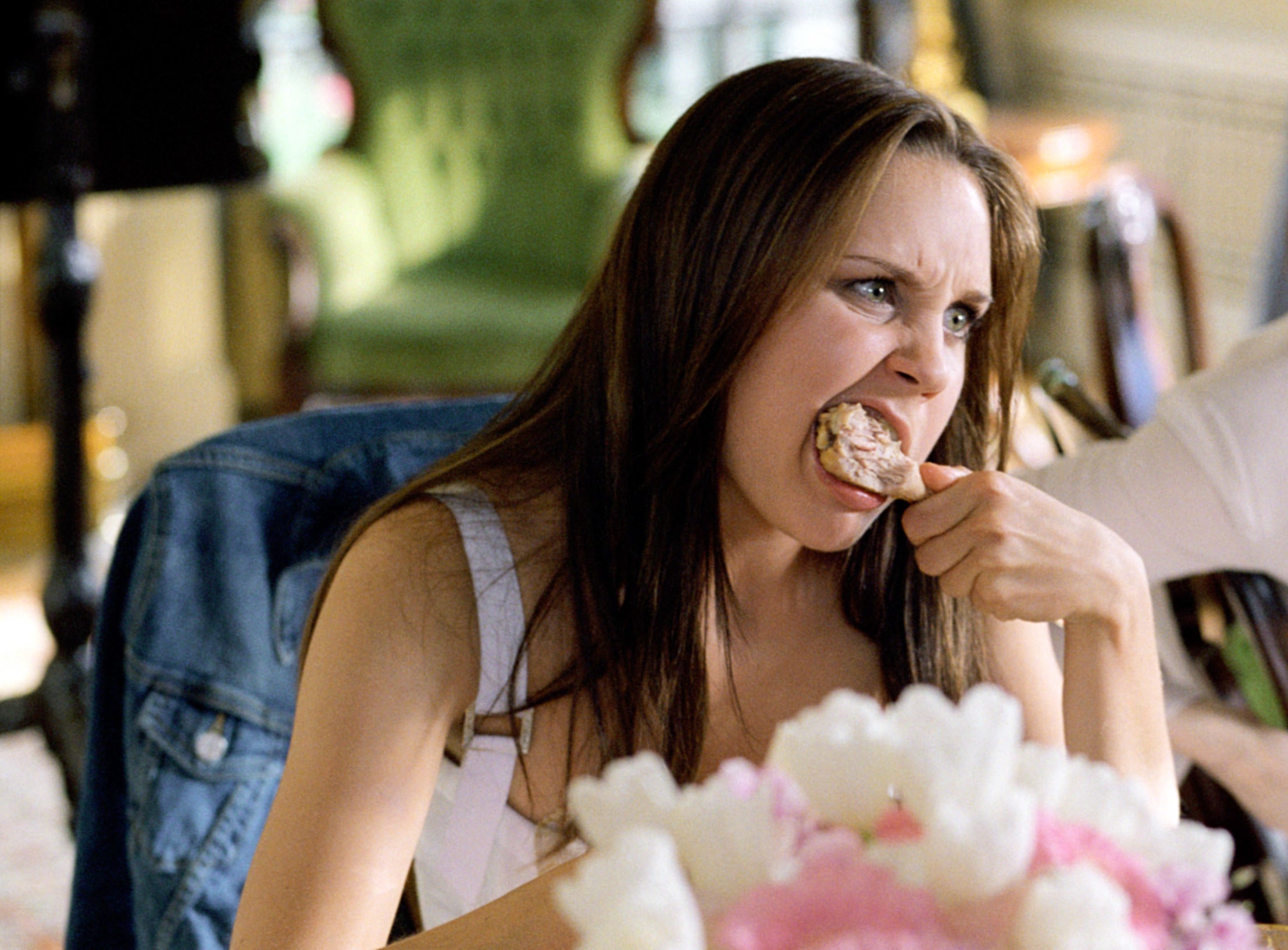 Viola eating chicken with a furious look on her face