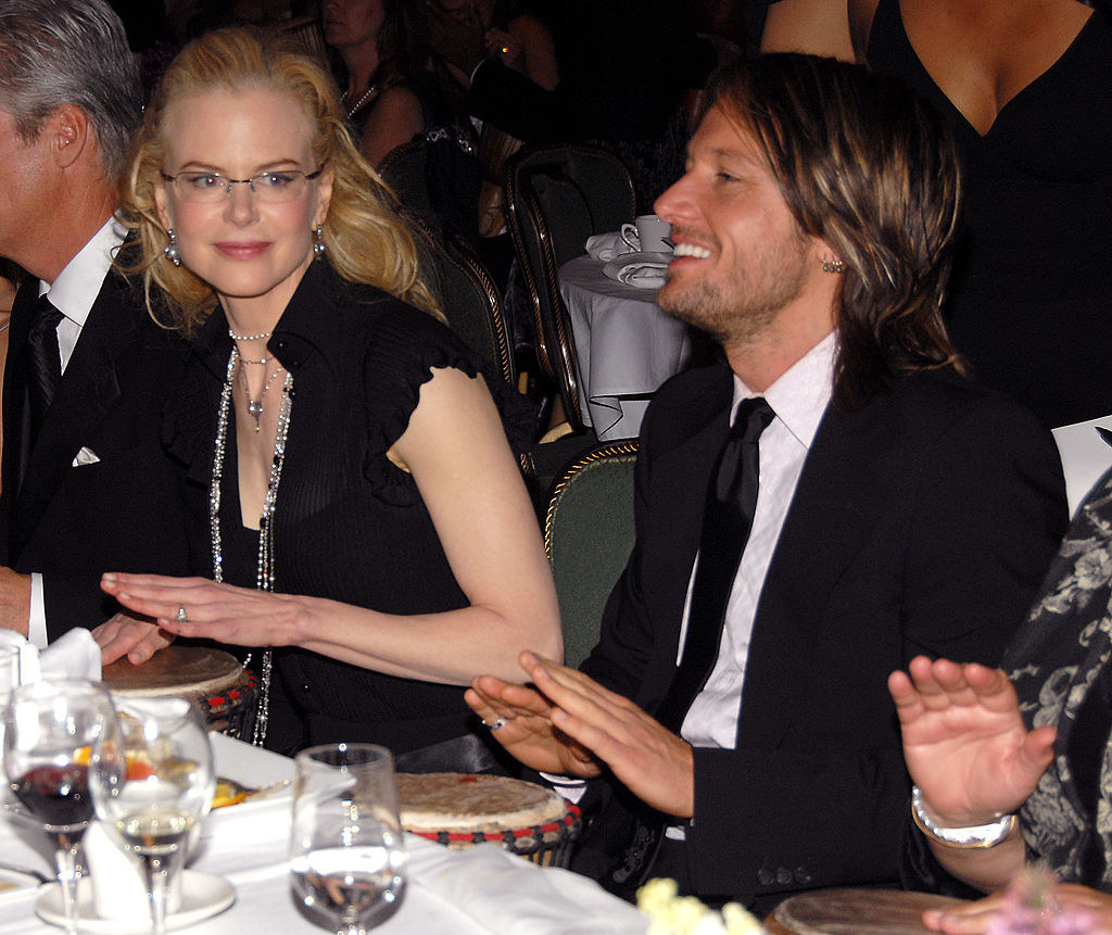 the couple is clapping at a dinner