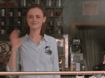 Rory Gilmore waving in a scene from Gilmore Girls