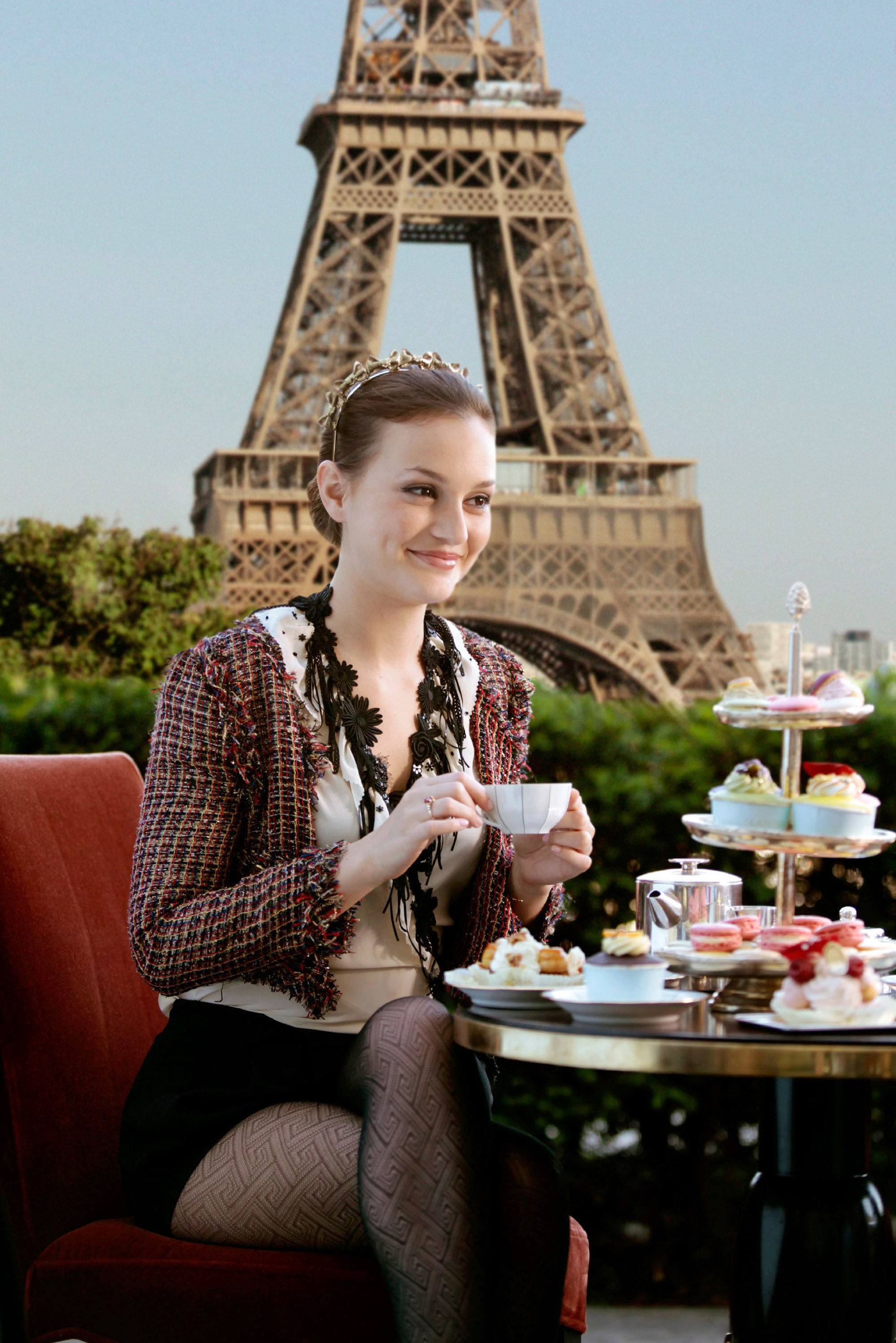 Blair sipping tea in front of the Eiffel Tower