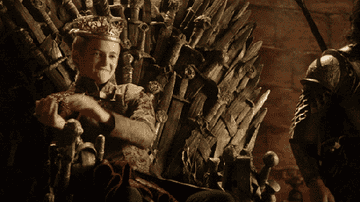 Joffrey sitting on the throne and clapping