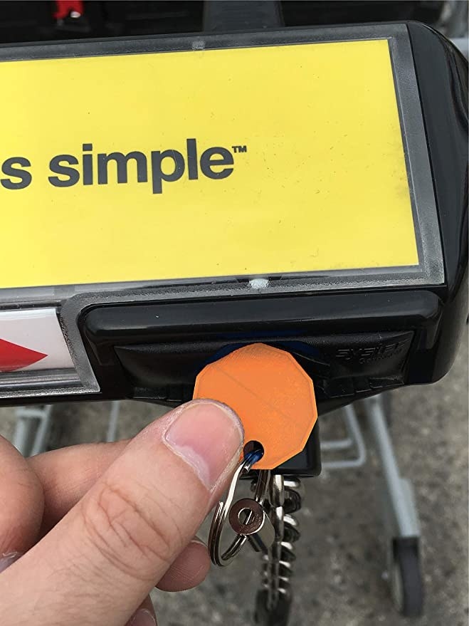a person putting the plastic loonie in their shopping cart