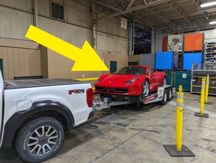 expensive sports car on a trailer in a company warehouse