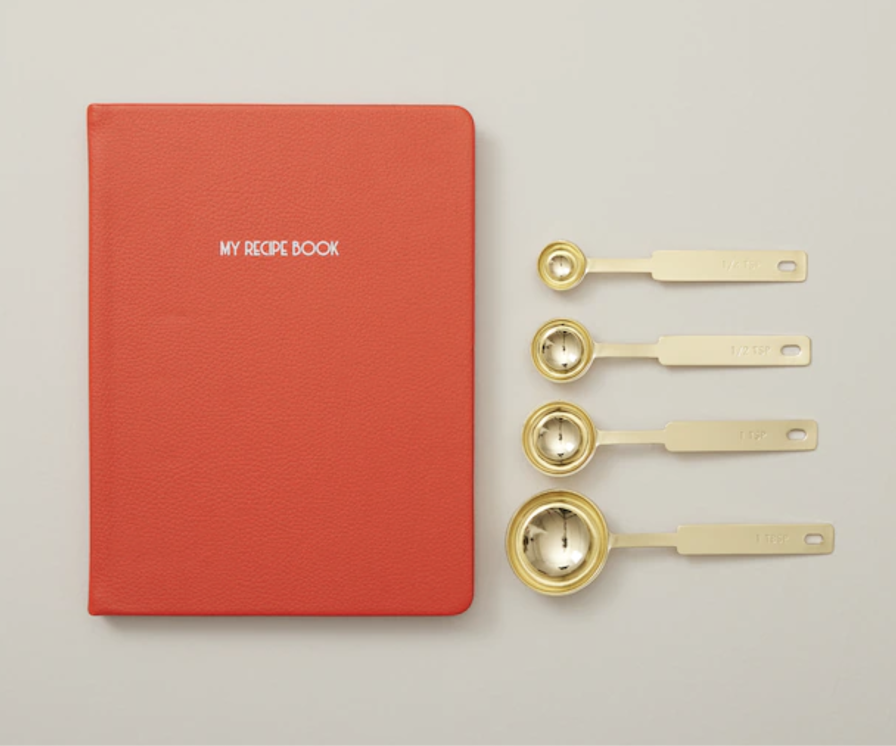 The measuring spoons next to the recipe book