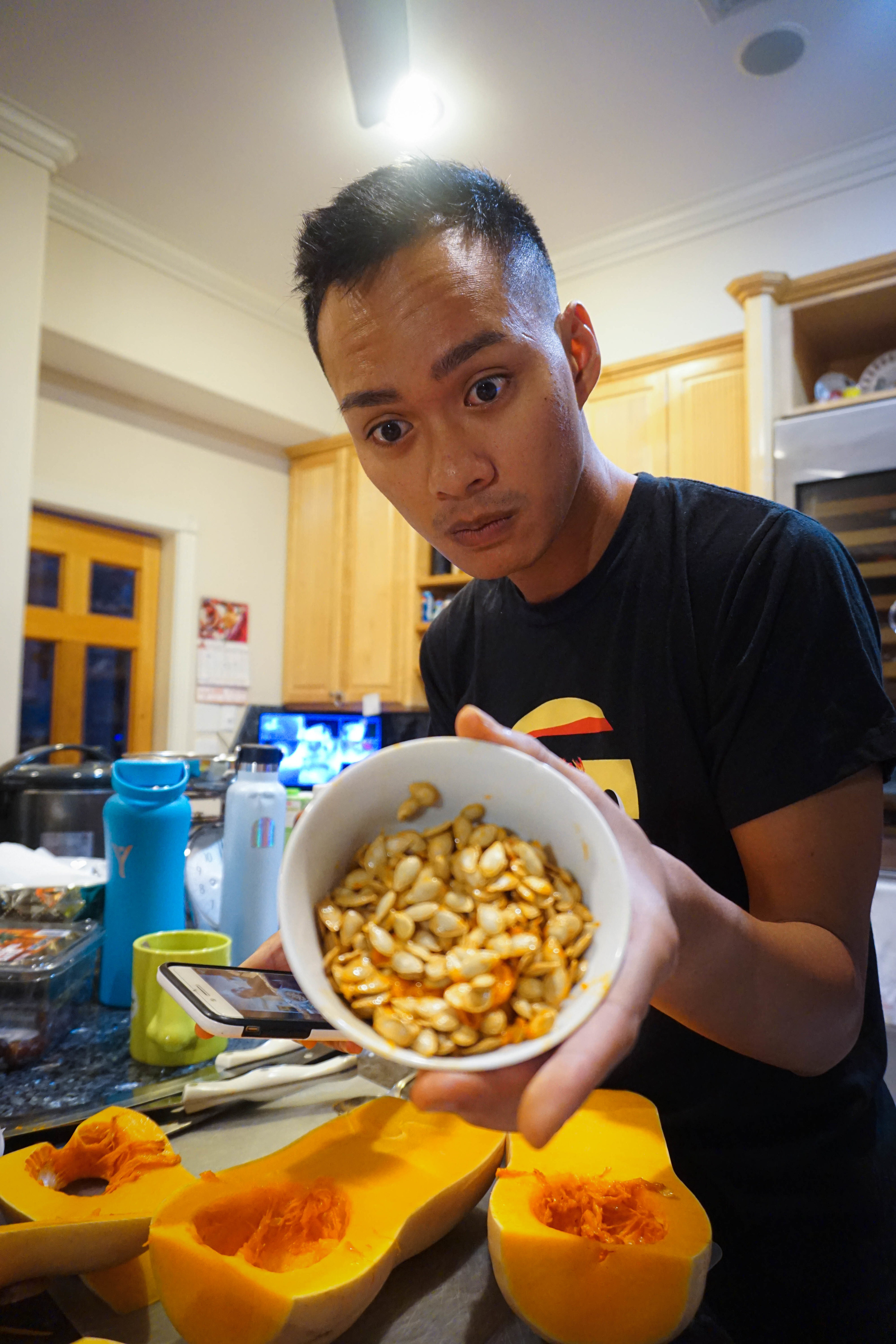 author holding butternut squash seeds in a bowl