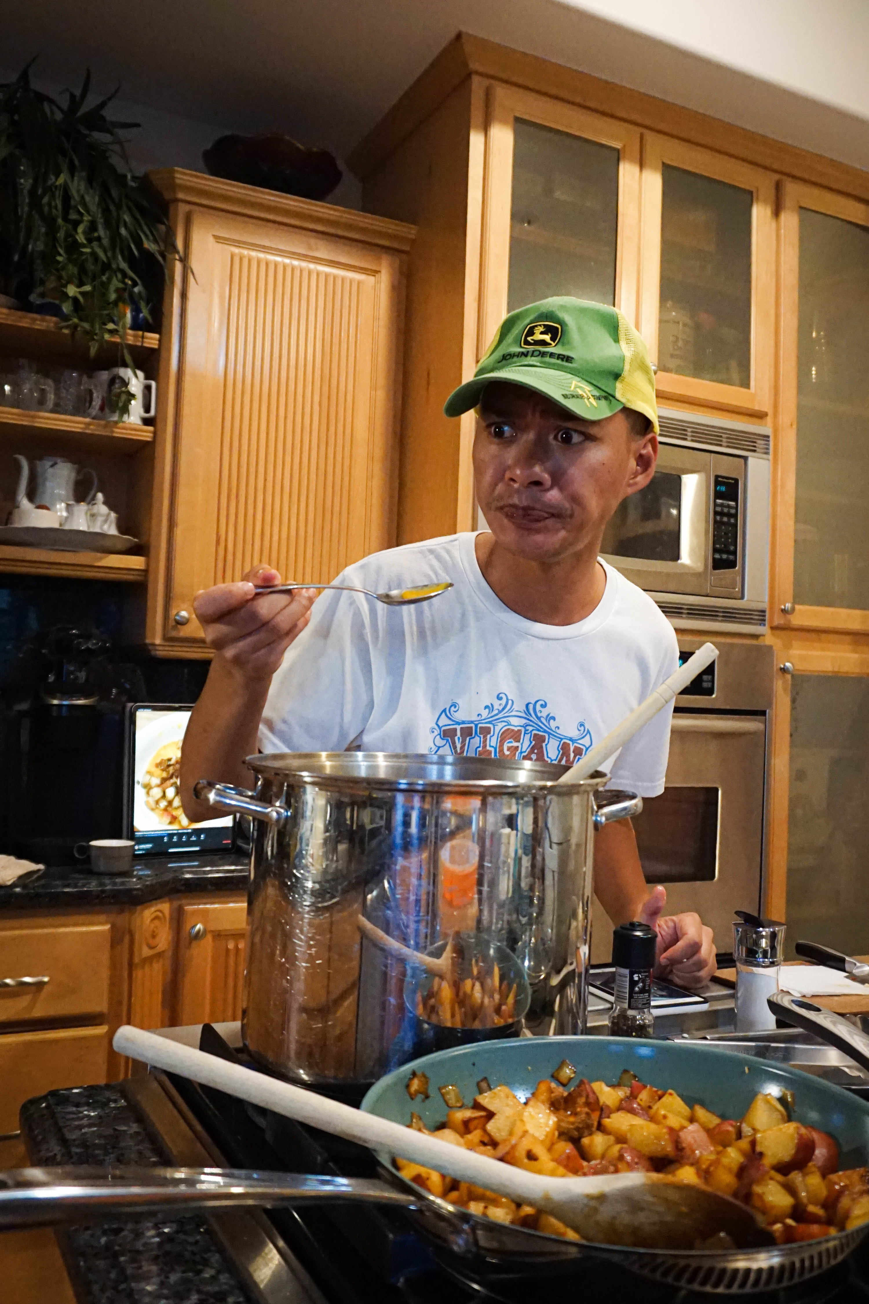 author taste testing the soup from the pot