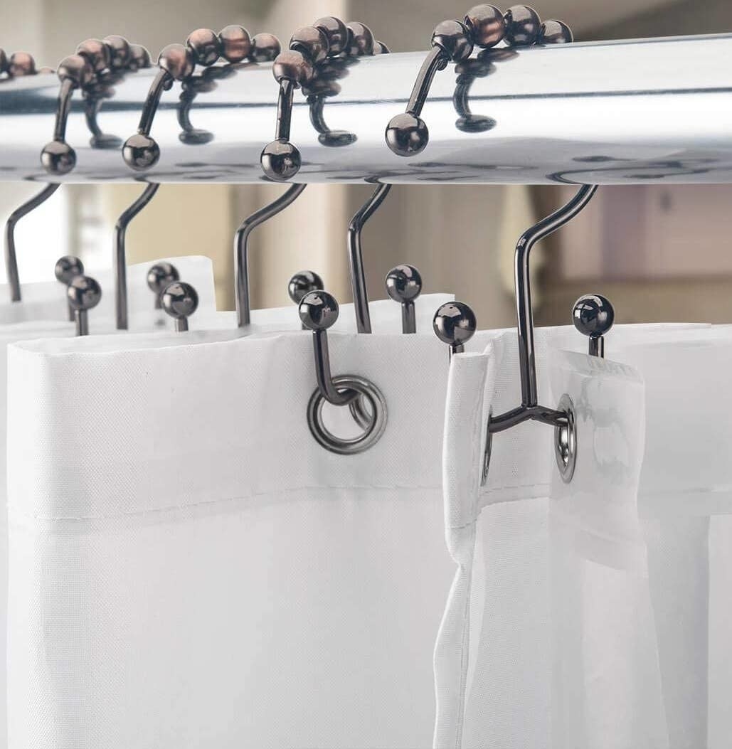 double sided hooks holding up a shower curtain
