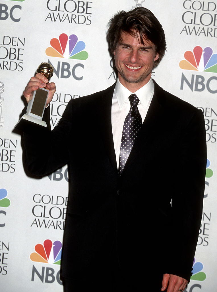Cruise smiling and holding a Golden Globe