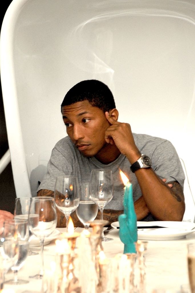 Pharrell at a dinner table