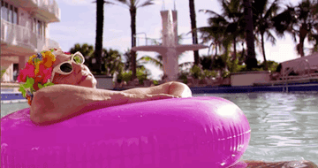 A woman lazily floating in a pool floatie