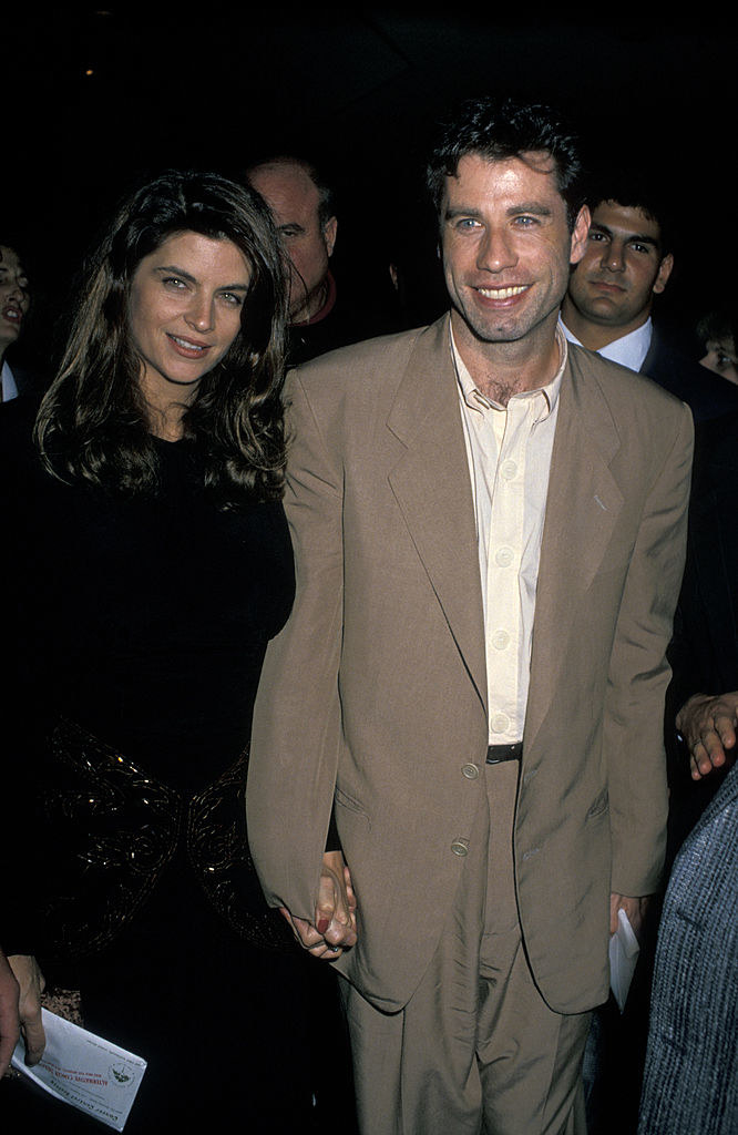 Travolta holding hands with Kirstie Alley