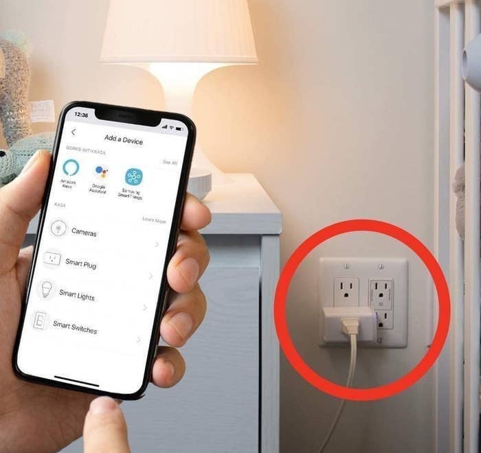 a person using a phone to control devices plugged into the smart plug
