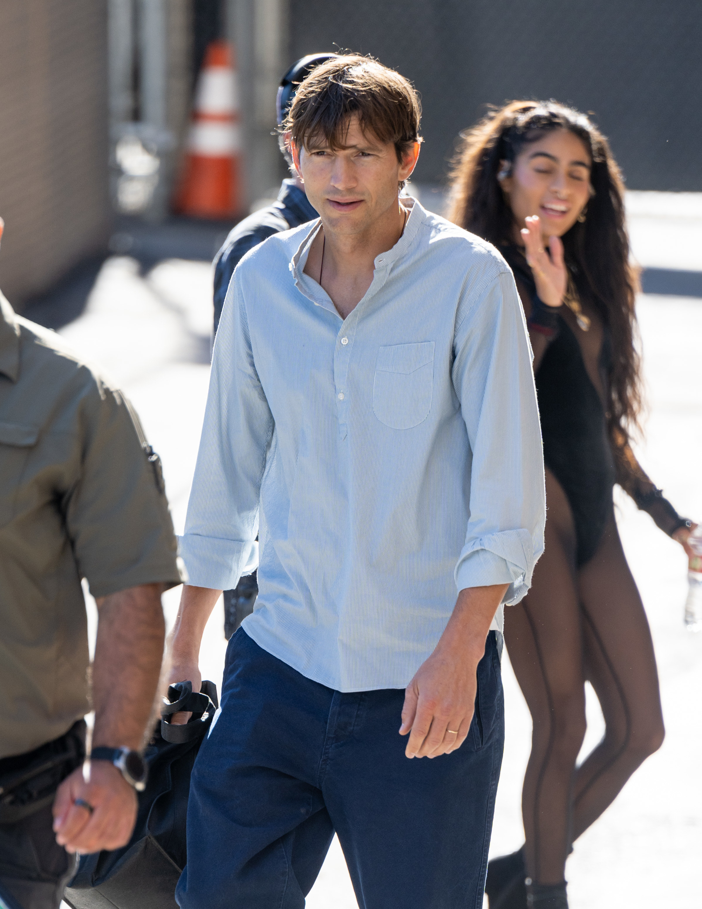 Kutcher walking on the sidewalk