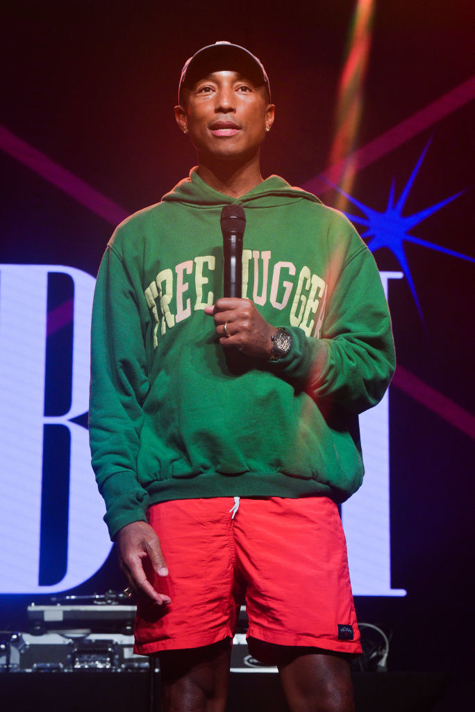 Pharrell holding a mic onstage