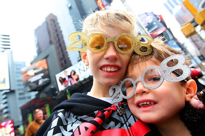 Kids celebrating in Times Square with &quot;2008&quot; eyeglasses