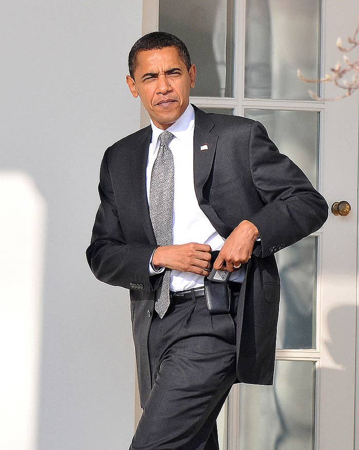 Barack Obama walking in a suit and tie