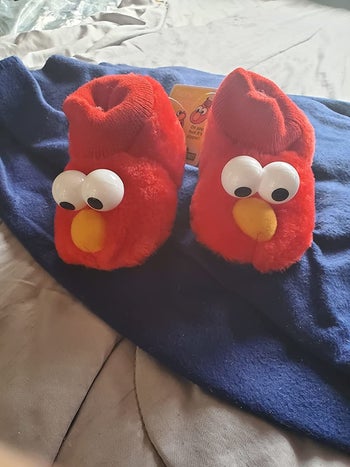 reviewer's photo of the red Elmo slippers