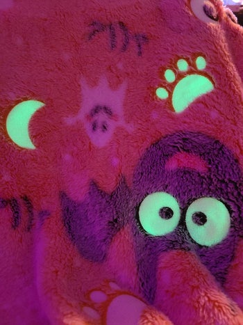 reviewer's photo showing the blanket glowing in the dark