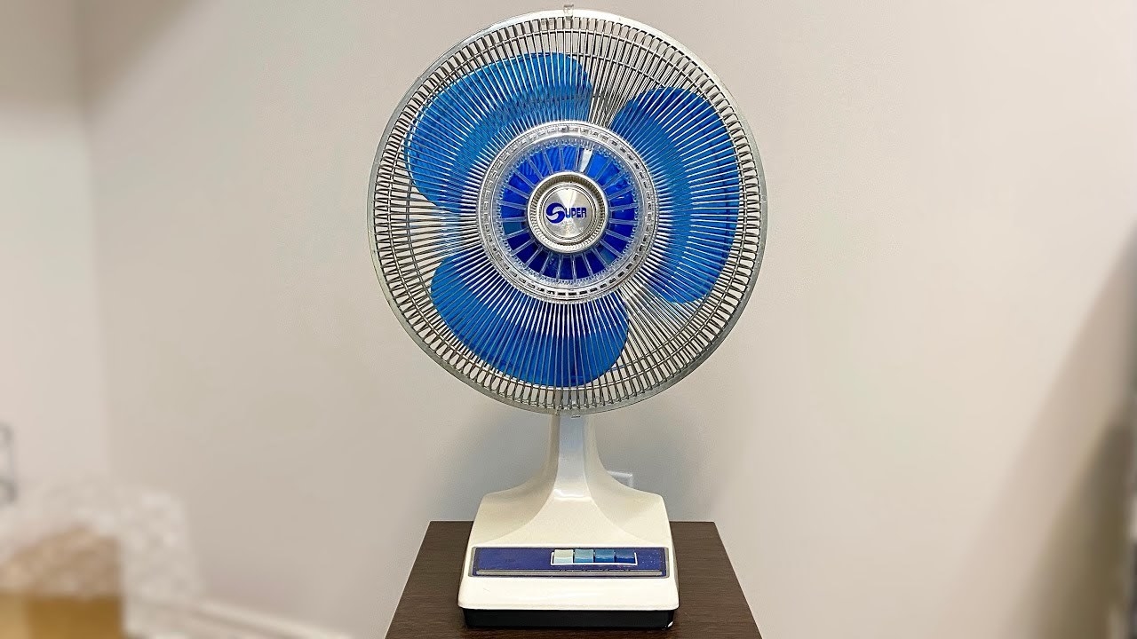 A blue fan on a small table