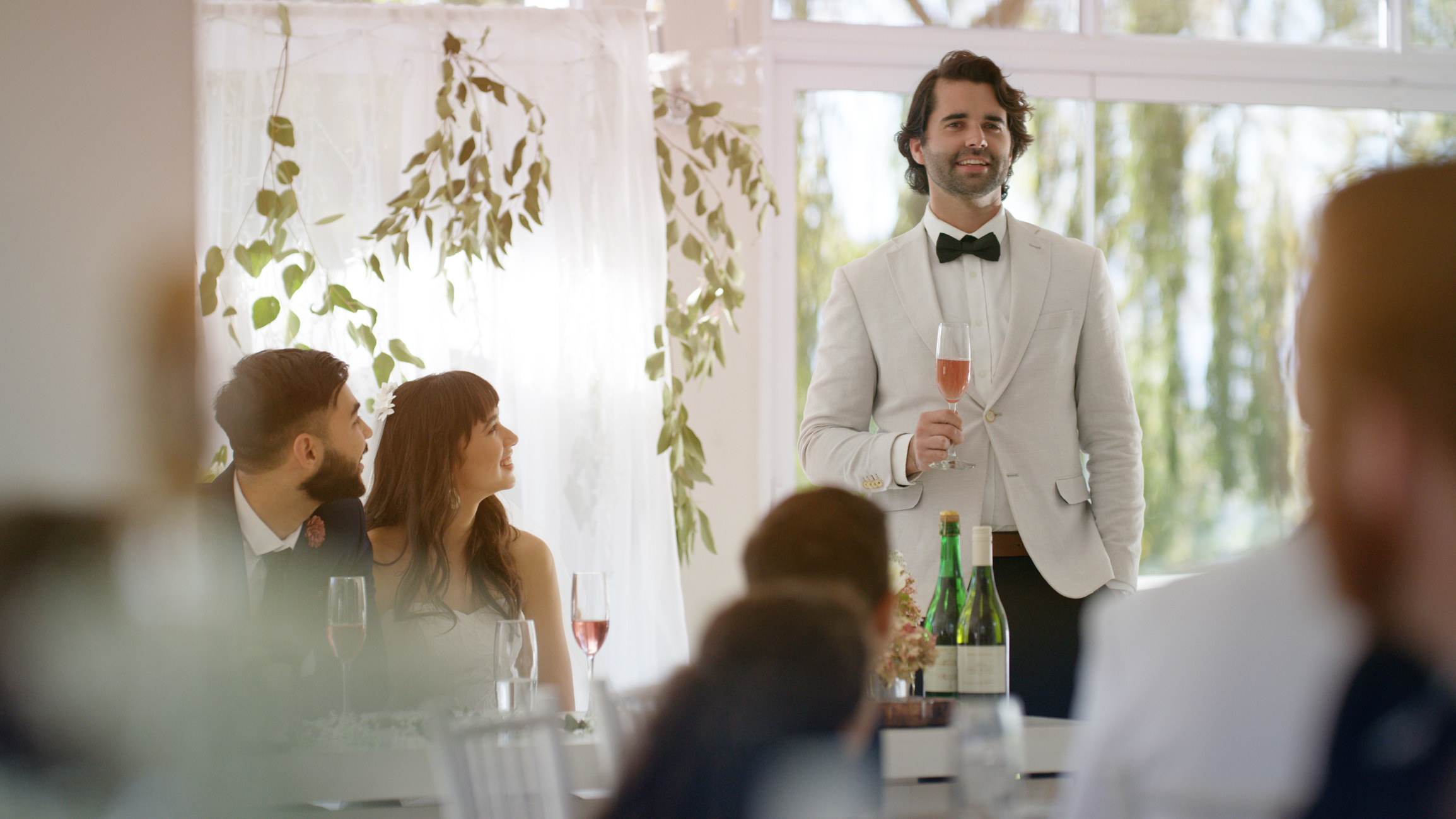 A man giving a speech at a wedding