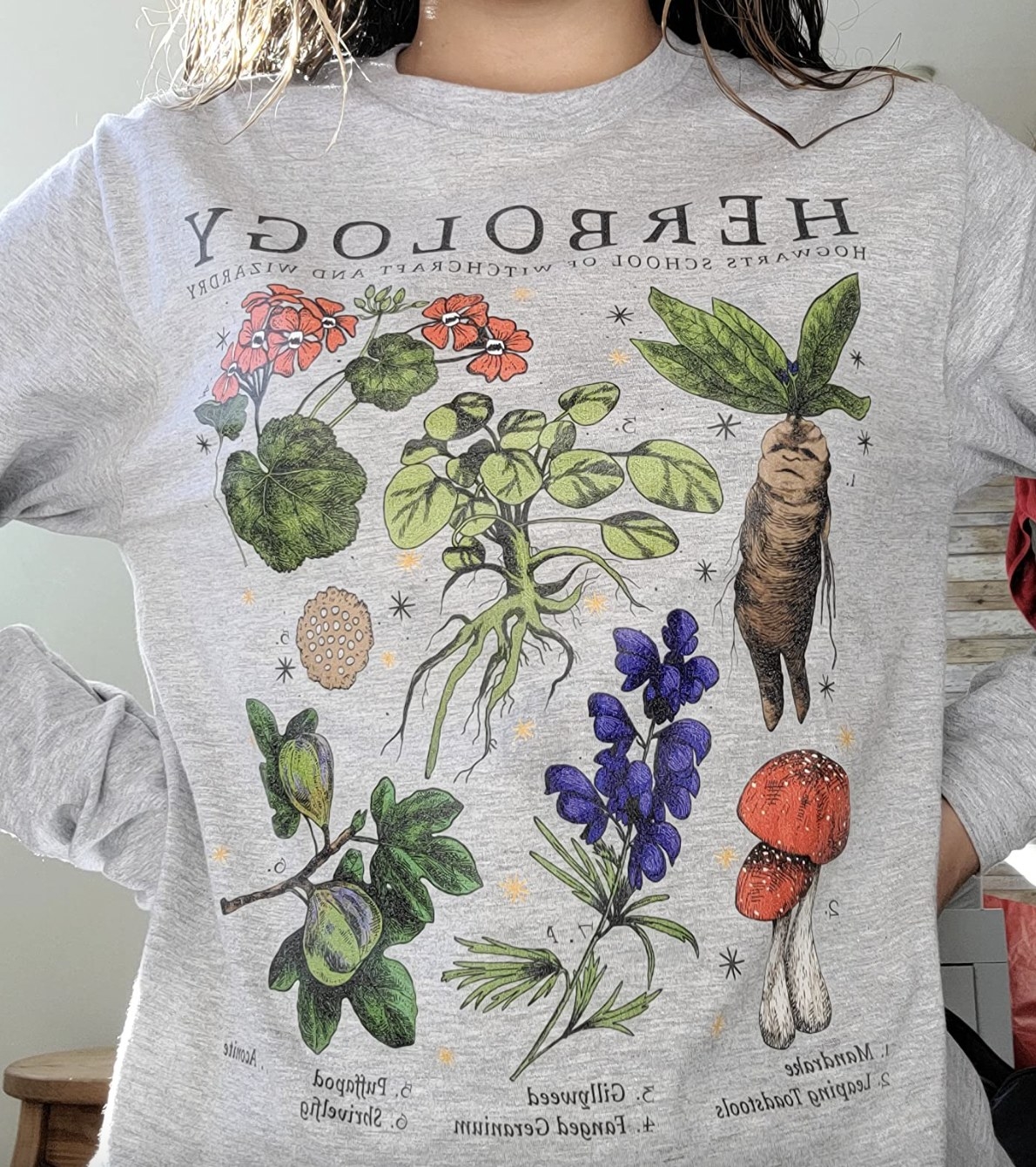 reviewer wearing herbology shirt