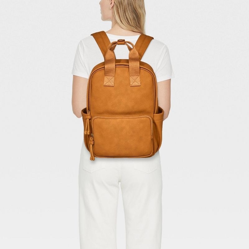 model wearing brown backpack