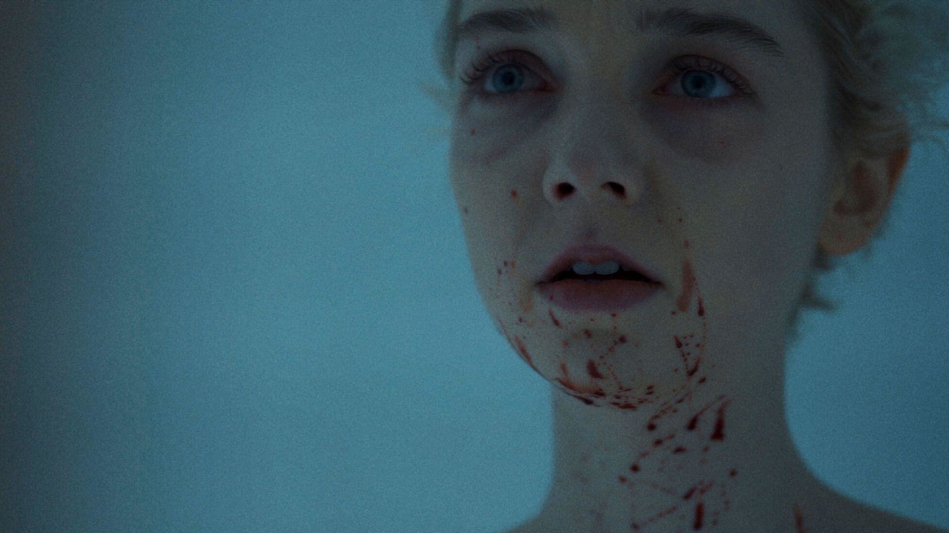 A young woman splattered with blood stares into a mirror in &quot;Come True&quot;