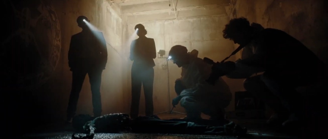 A group of forensic investigators wearing headlamps investigate a ritualistic crime scene in &quot;Charismata&quot;