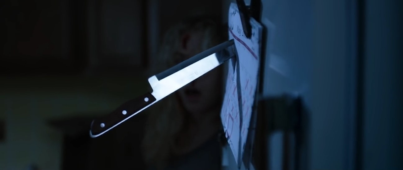 A scared woman narrowly avoid a thrown knife in her kitchen in &quot;Apartment 212&quot;