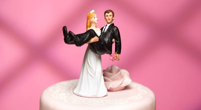 Wedding cake toppers of a bride carrying the groom