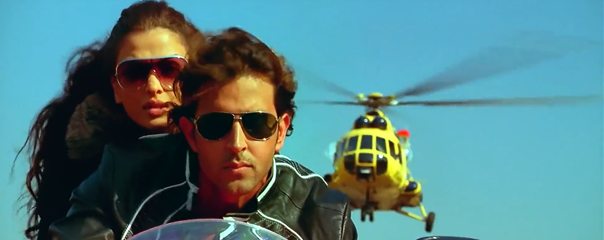 Aishwarya Rai and Hrithik Roshan on a bike being hunted down by a helicopter