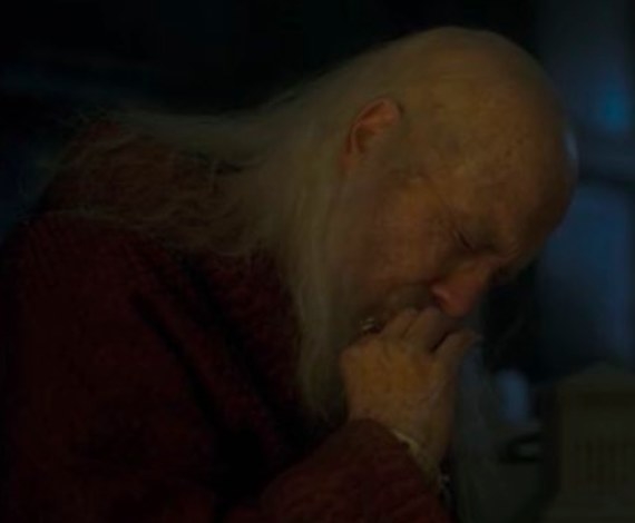 Viserys cries while kissing a ring on his finger