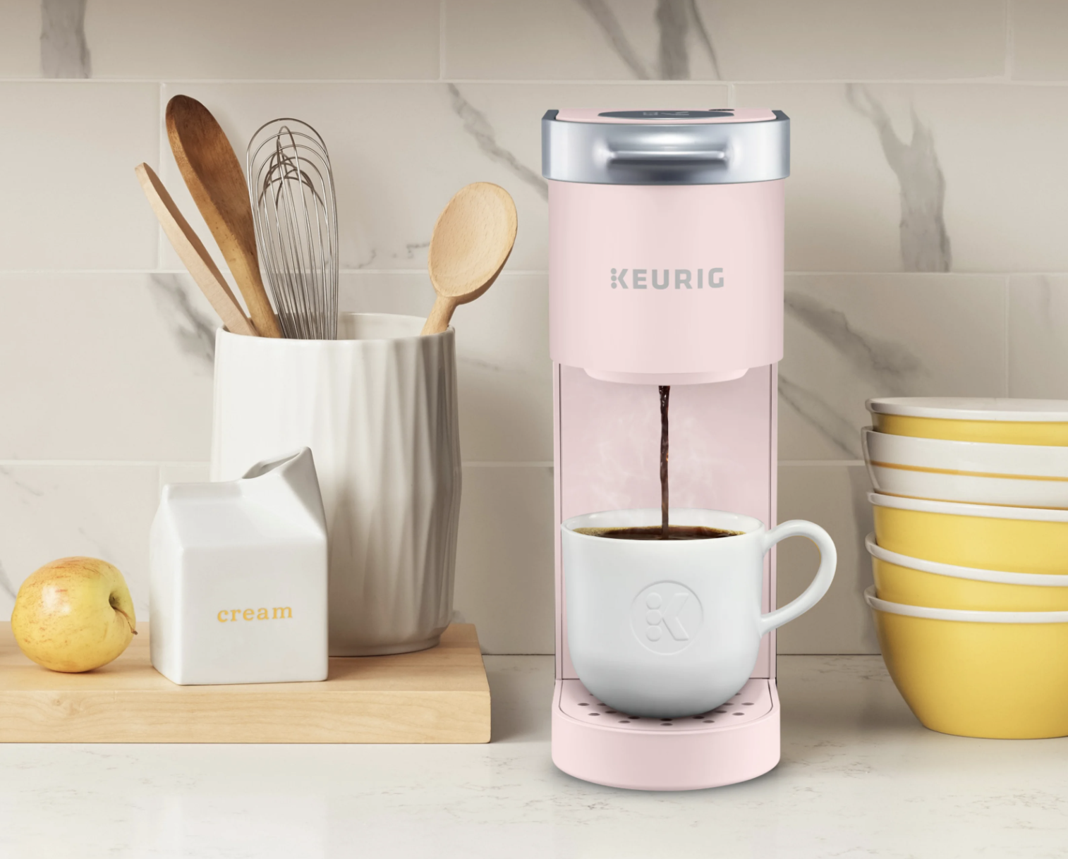 the pink coffee maker on a countertop