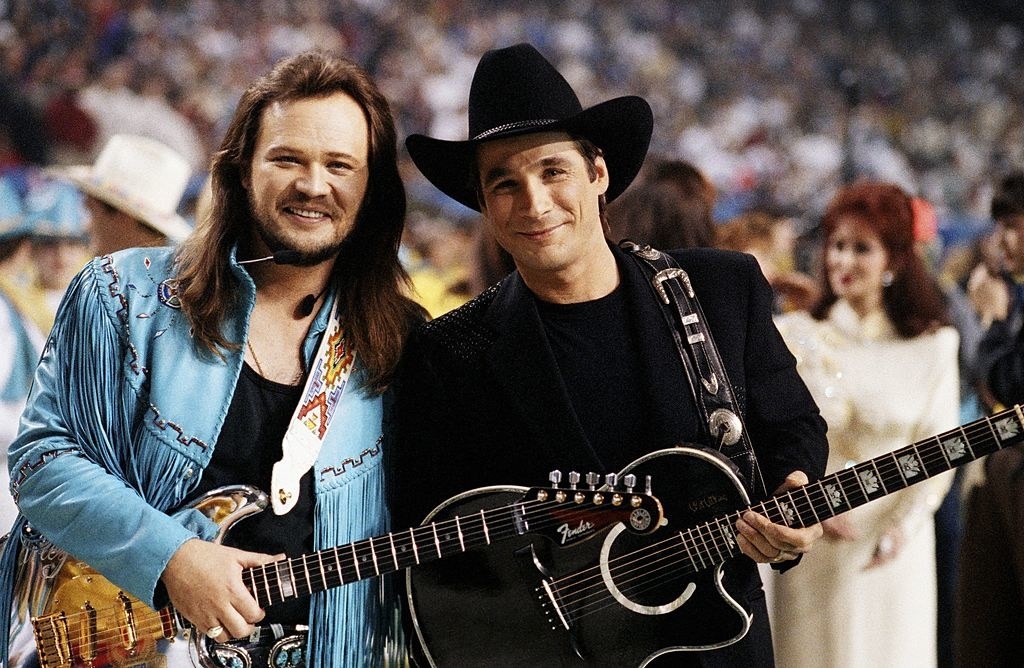 Clint and Travis holding guitars