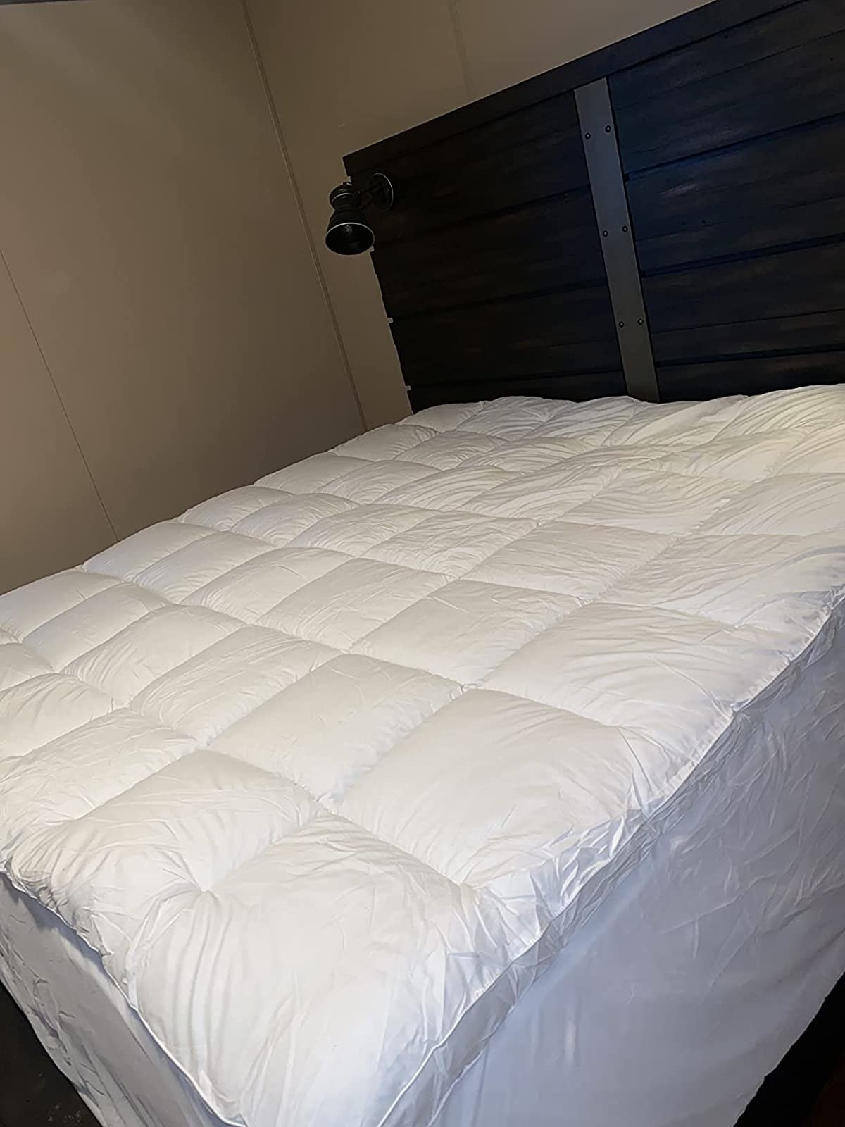 Reviewer image of white mattress topper on a bed