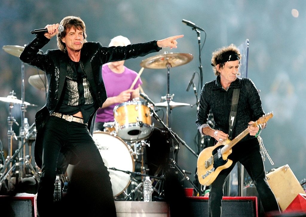 Mick Jagger and Keith Richards performing, with Charlie Watts behind them