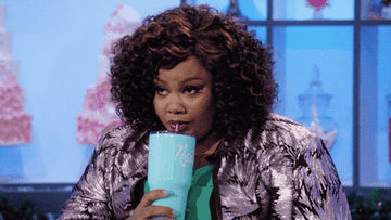 Nicole Byer drinking from cup