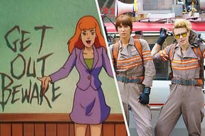 Daphne stands in front of a sign that says, "Get Out Beware" and two of the female Ghostbusters