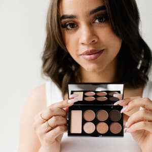 model holding up an eyeshadow palette