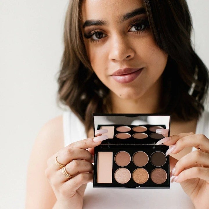 model holding up an eyeshadow palette