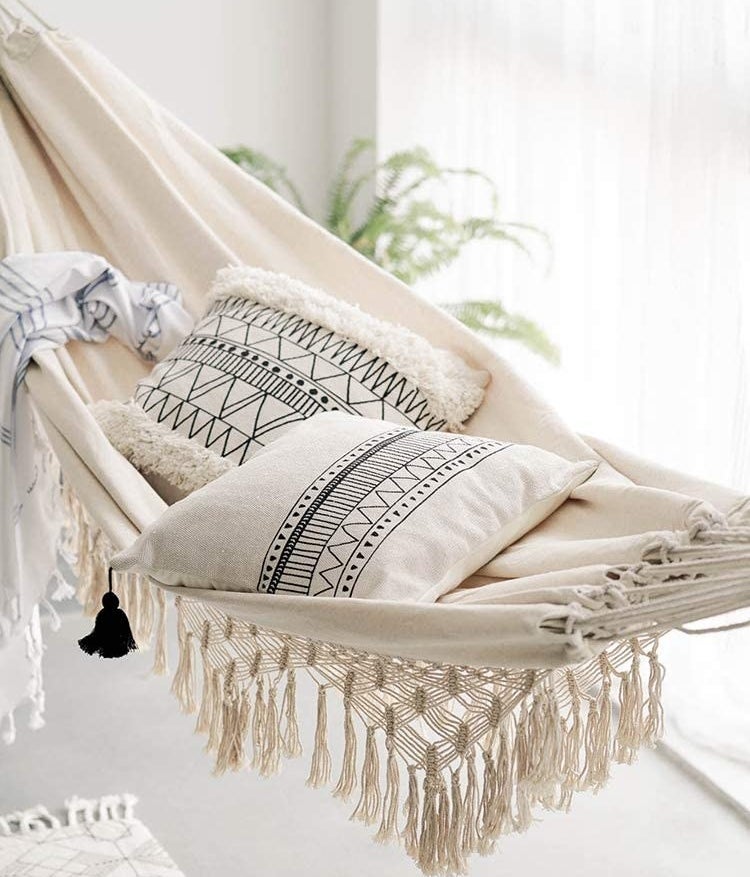 an indoor hammock with cozy pillows on it