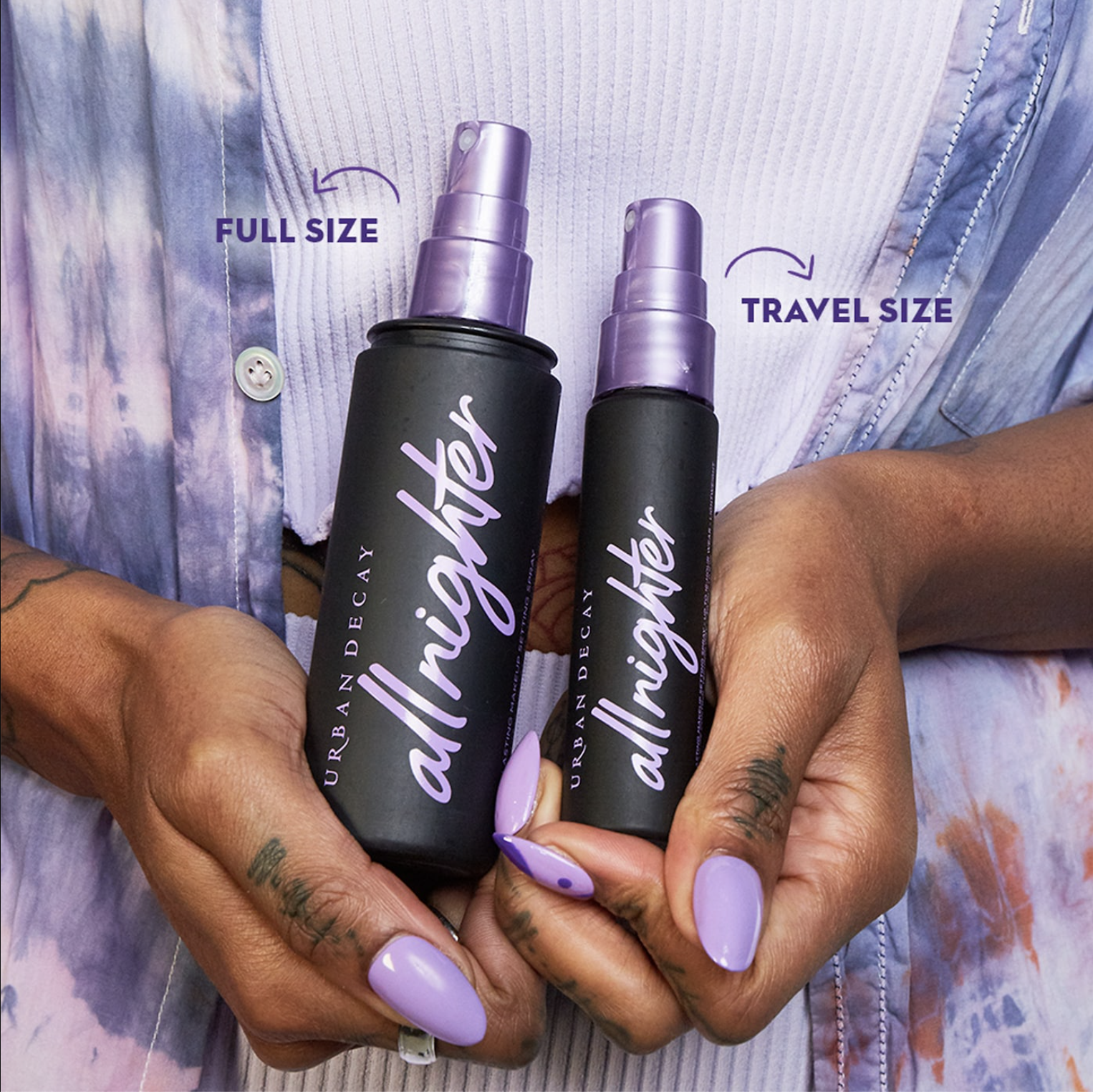 A person holding two bottles of the setting spray