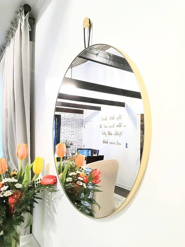 a reviewer photo of the gold trimmed mirror