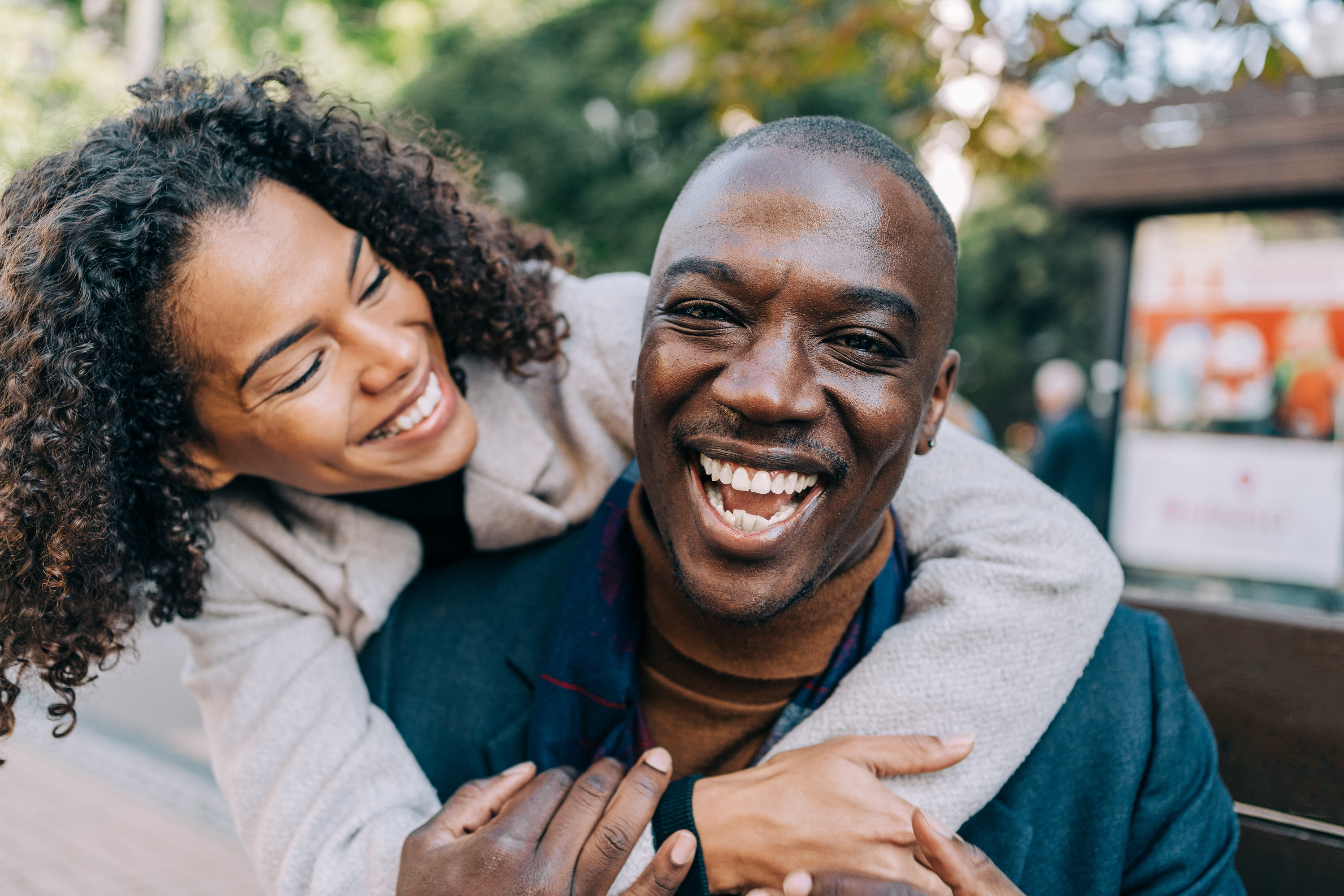 A man and a woman laugh and embrace