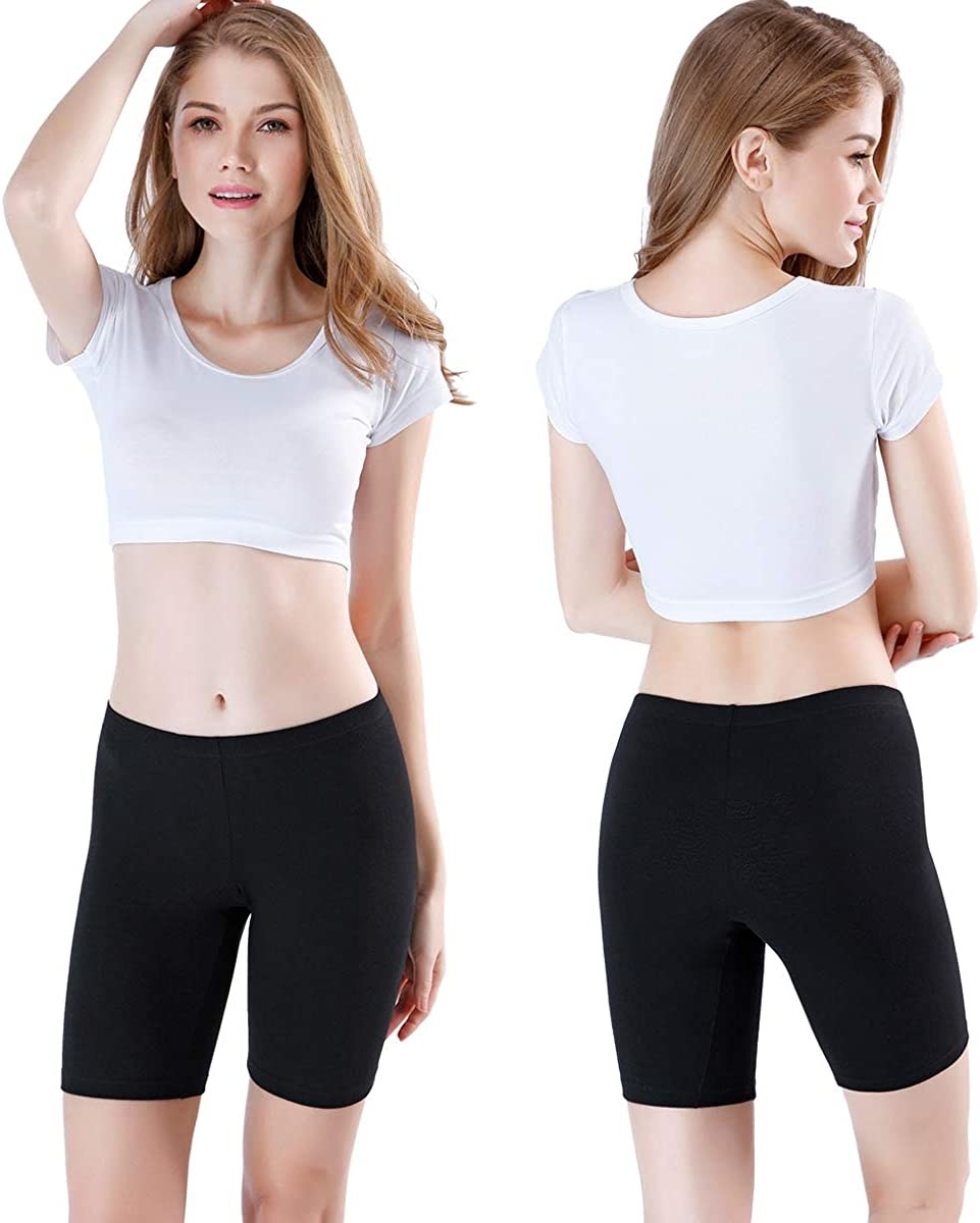 a person showing the front and back of the bike shorts against a plain background
