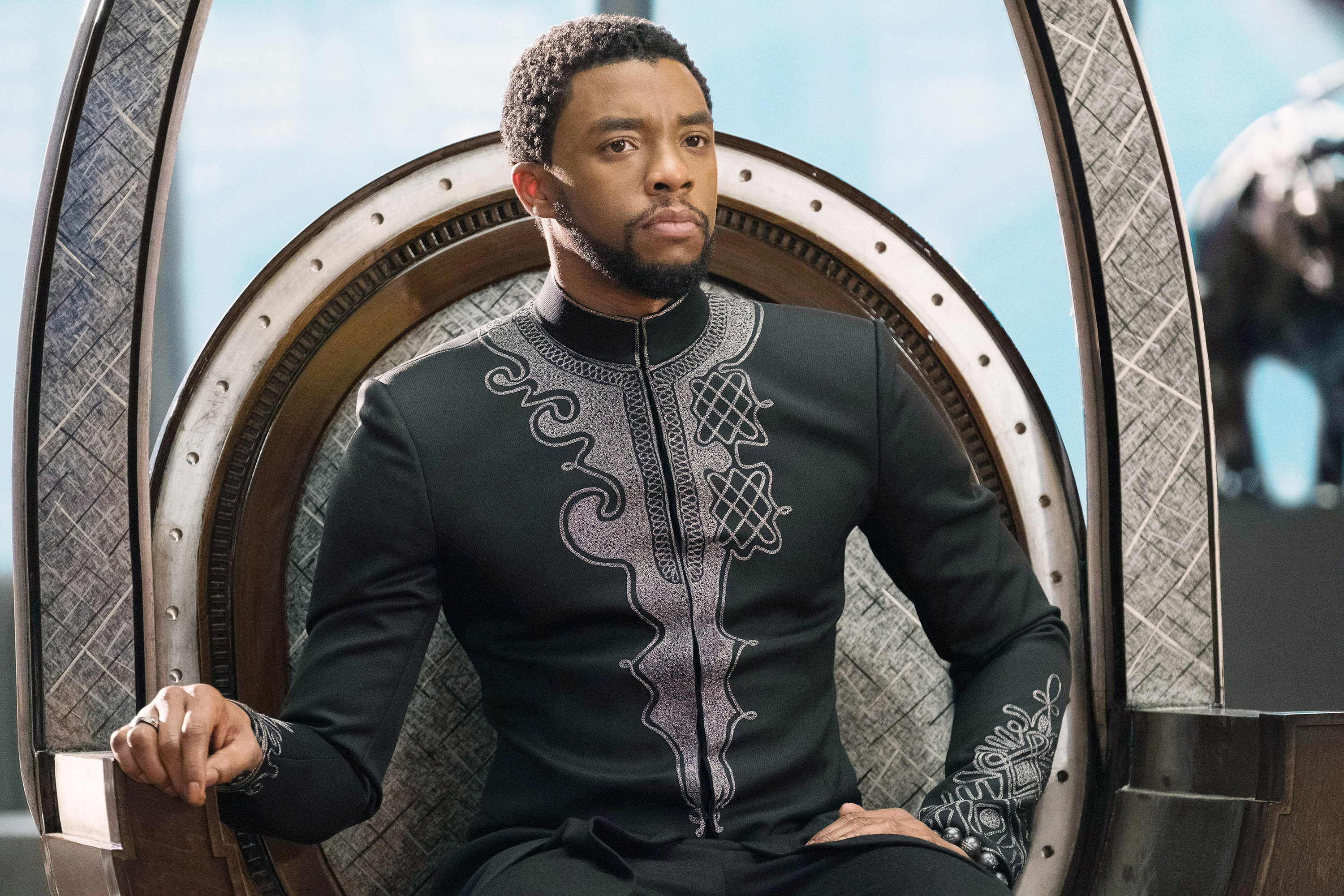 Chadwick sits on a throne in the film