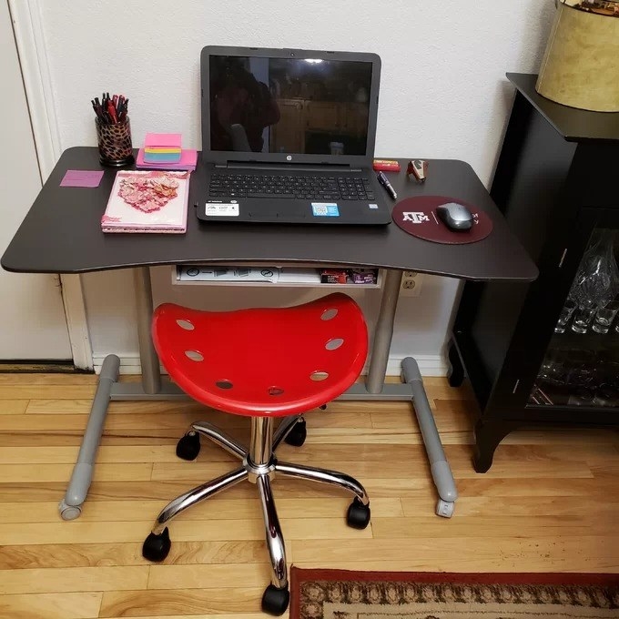 a reviewer photo of the red stool under a desk