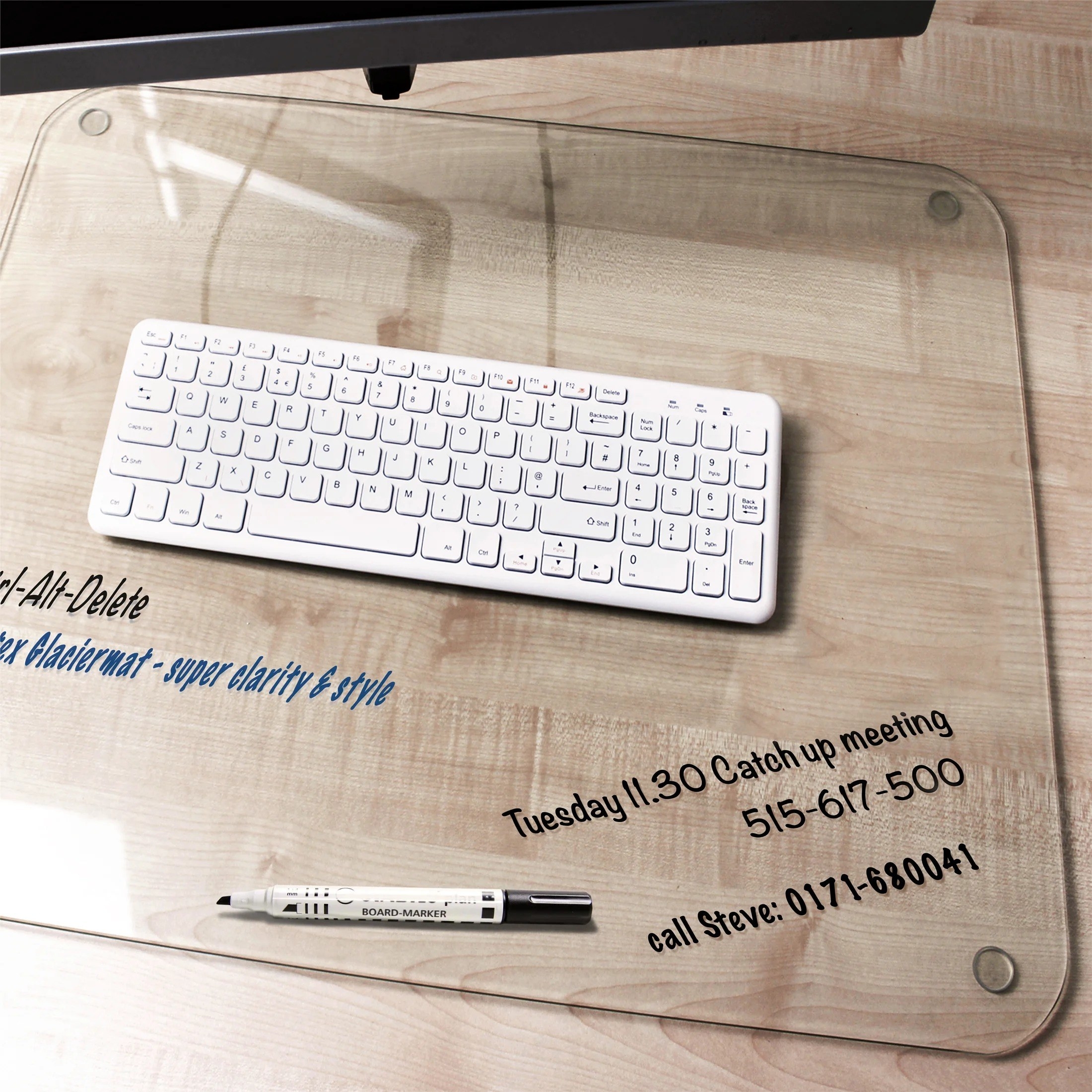 the glass desk pad with notes written on it by a white erase marker