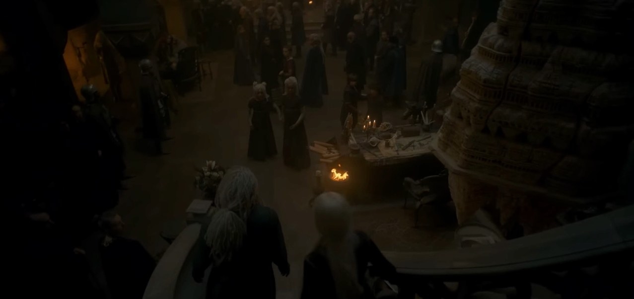 A crowd in the Hall of Nine; Corlys and Rhaenys rush down the stairs
