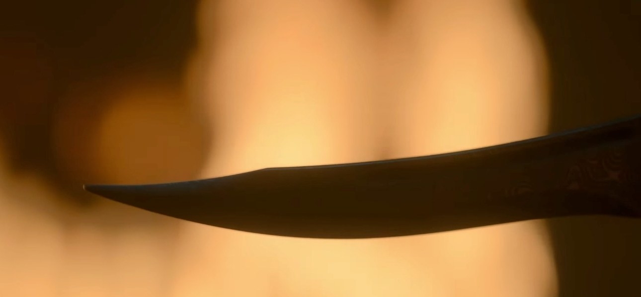A dagger in front of a fire